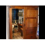 An oak Arts & Crafts style wardrobe with mirrored