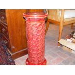 A Burmantofts pottery red glazed jardiniere stand