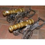 A pair of model brass cannons on cast iron carriag