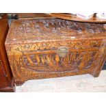 An oriental carved camphorwood chest with brass lo