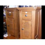 A pair of oak bedside cabinets