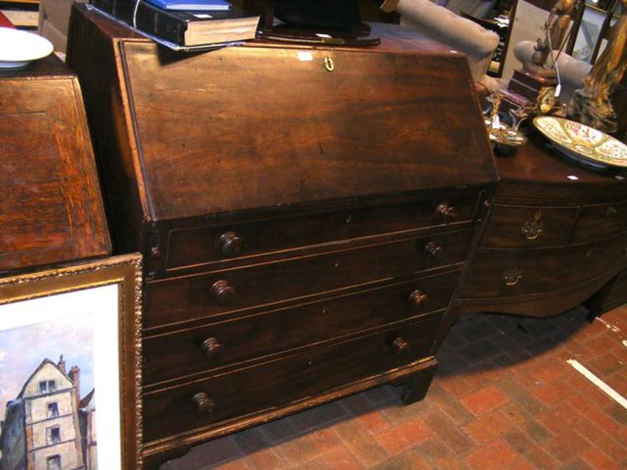 A Georgian mahogany fall front bureau with four dr