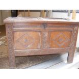 A carved oak coffer with diamond design to front p