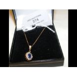 A sapphire and diamond pendant on chain