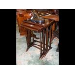 A nest of three mahogany occasional tables