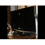 A Samsung 31inch flat screen TV with remote