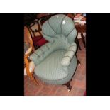 A Victorian button back armchair with cabriole fro