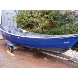 A blue and white open boat 'Rosie' - on two wheel