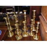Five pairs of brass candlesticks