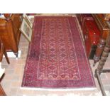 A Middle Eastern rug with red ground and geometric