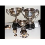 Three silver trophies on stands, together with thr