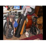 Two bags of golf clubs, together with a trolley