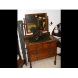 An oak dressing table with metal candle sconces