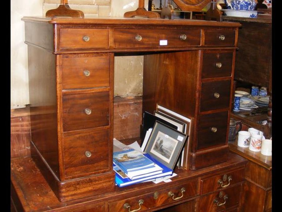 A mahogany knee-hole desk with inset leather top -