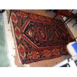 An antique Middle Eastern rug with geometric borde