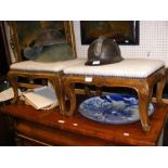 A pair of antique footstools on carved cabriole su