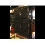 An antique highly carved Chinese hardwood two sect