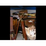 A reproduction brass telescope on tripod stand