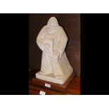 A carved stone bearded figure clasping book - heig