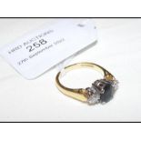 A sapphire and two stone diamond ring in gold sett