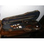 An old violin with bow in carrying case