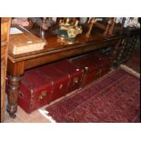 A Victorian long narrow mahogany table on reeded s