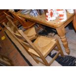 A pine farmhouse style dining table on turned legs