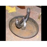 An antique cast metal boot scraper
