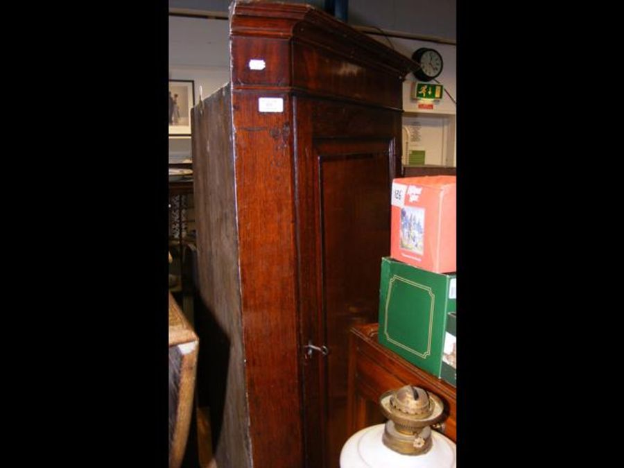 A Georgian cross banded oak corner cupboard