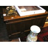 An antique panelled coffer with two drawers to the