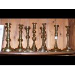 Four pairs of brass candlesticks
