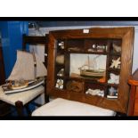 A wall mounted display cabinet containing maritime