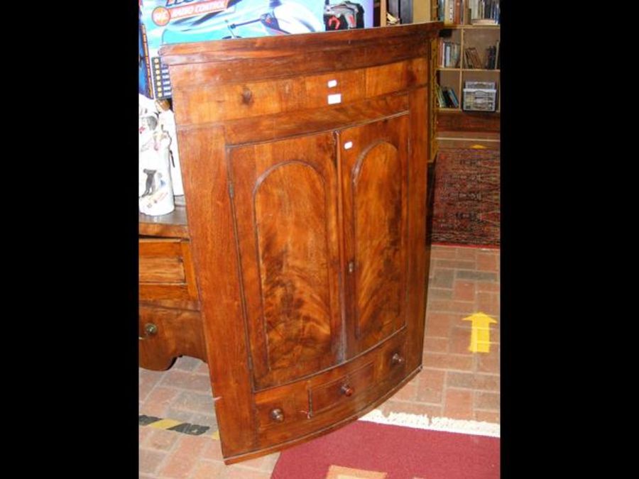 A 19th century mahogany bow fronted corner cupboar