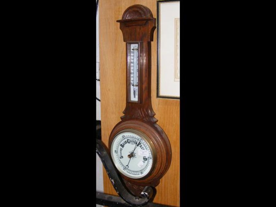 A wall barometer/thermometer