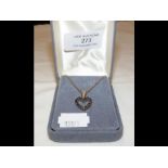 A heart shaped sapphire pendant on chain