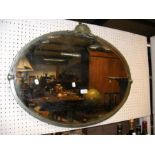 An 80cm wide decorative oval wall mirror