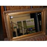 A bevelled wall mirror in gilt frame