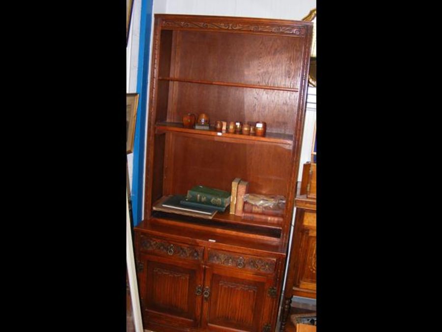 An oak display unit with drawers and cupboards und