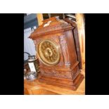 An oak cased mantel clock with two train movement