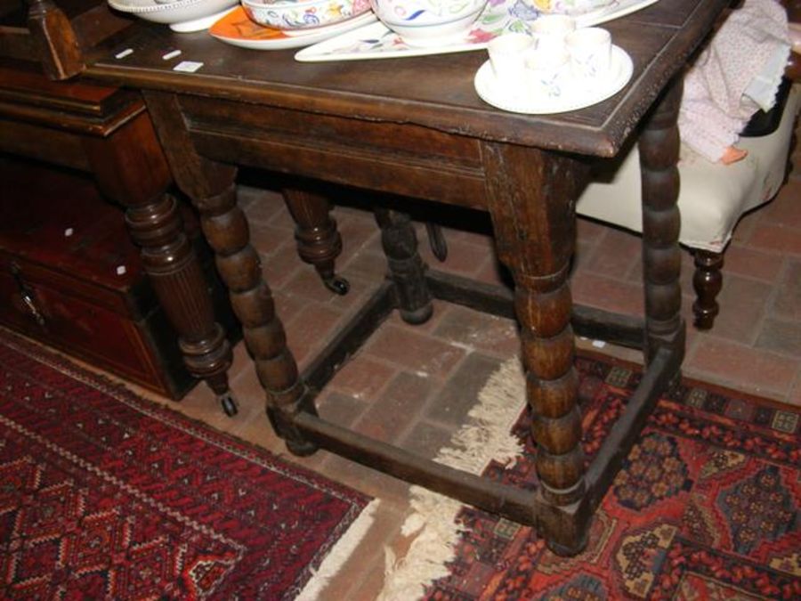 An oak side table on bobbin support