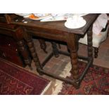 An oak side table on bobbin support