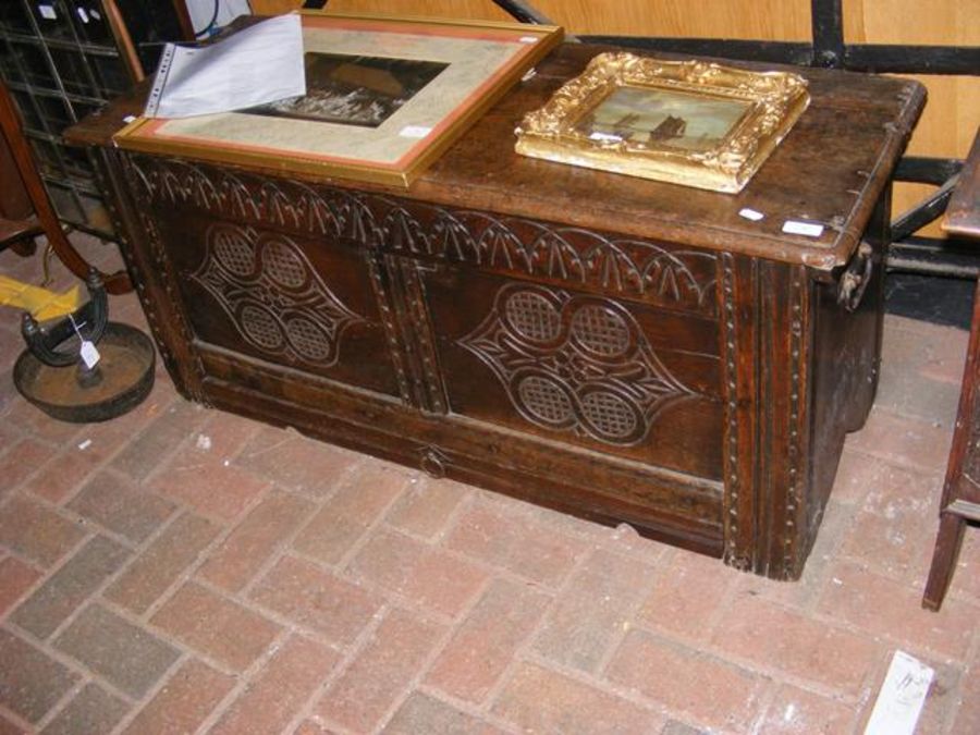 A period oak panelled coffer with carved decoratio