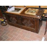A period oak panelled coffer with carved decoratio