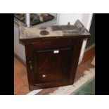 A small antique oak hanging cupboard