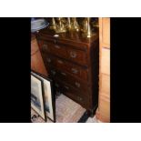 A mahogany chest with brushing slide and four draw