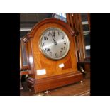 An inlaid mahogany two train mantel clock