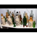 A collection of stoneware ginger beer bottles and