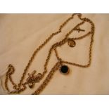 An antique yellow metal longuard chain with 15ct gold clasp and attached gold pendants