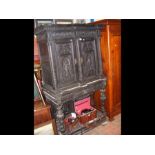 An antique ornately carved oak cabinet