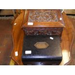 A carved oak jewellery box, together with one othe